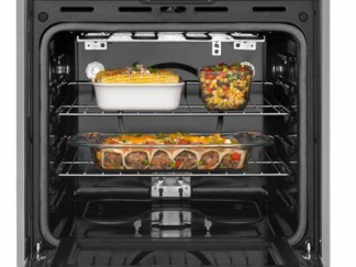 Black glass built-in oven with touch controls in a stylish kitchen. FYIRWA TRADING LTD